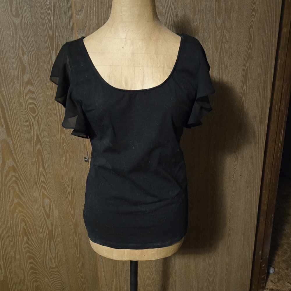 Large, black, cotton spandex with poly ruffled cropped sleeves.